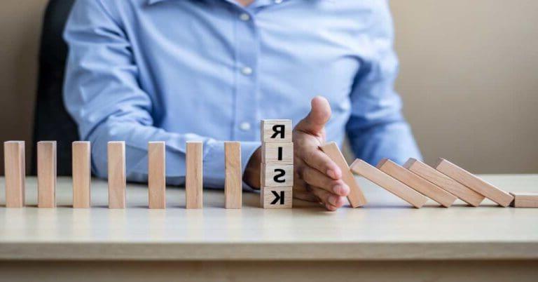 Businessman hand Stopping Falling wooden Blocks or Dominoes. Business, Risk Management, Solution, Insurance and strategy Concepts
